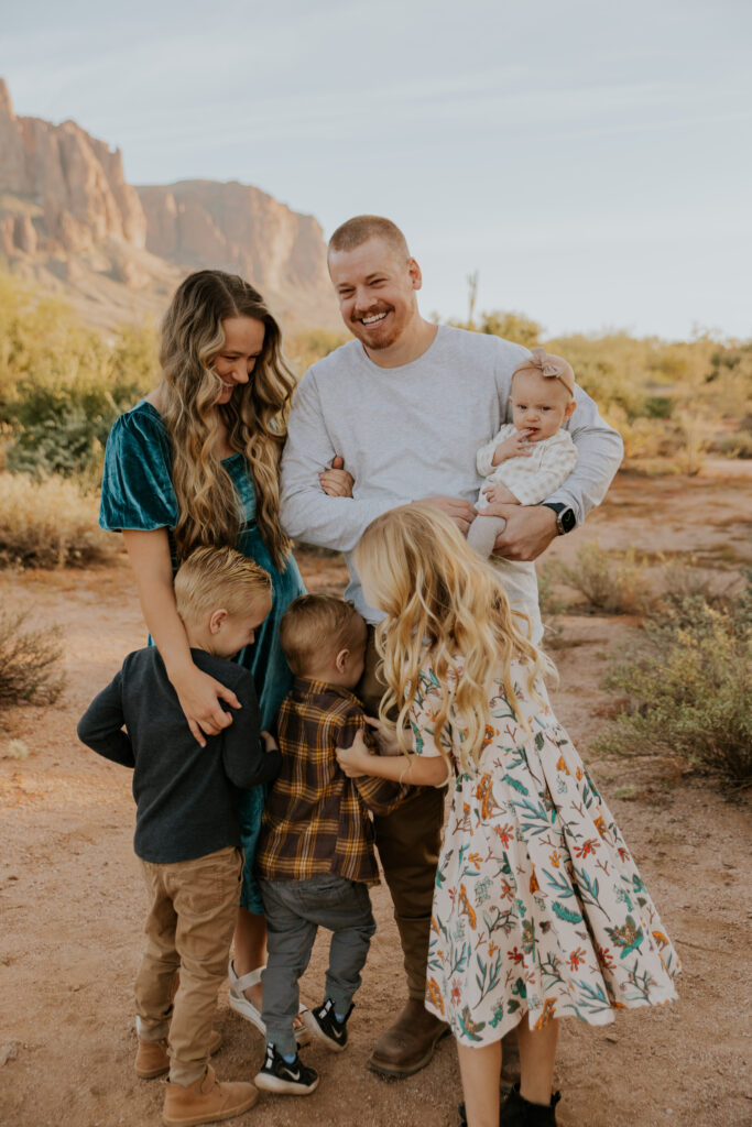 The Rossel family laughs together during a big group hug during their session at Lost Dutchman State Park. #Arizonfamilyphotographer #Phoenixphotolocations #superstitionmountains #familyphotographer #ChelseyMichellePhotography #Scottsdalephotographer #familyphotosinspo #LostDutchmanStatePark