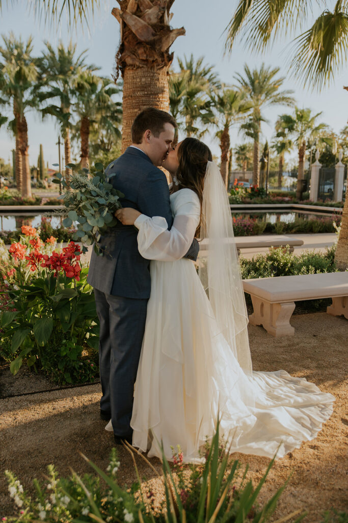 Romantic wedding photo of bride and groom kissing on Mesa temple grounds. Mesa temple photo inspiration bridal portrait inspiration #ChelseyMichelleCoPhotography #Arizonaweddingphotographer #Phoenixphotographer #Mesaphotographer #Gilbertphotographer #ArizonaLDSwedding