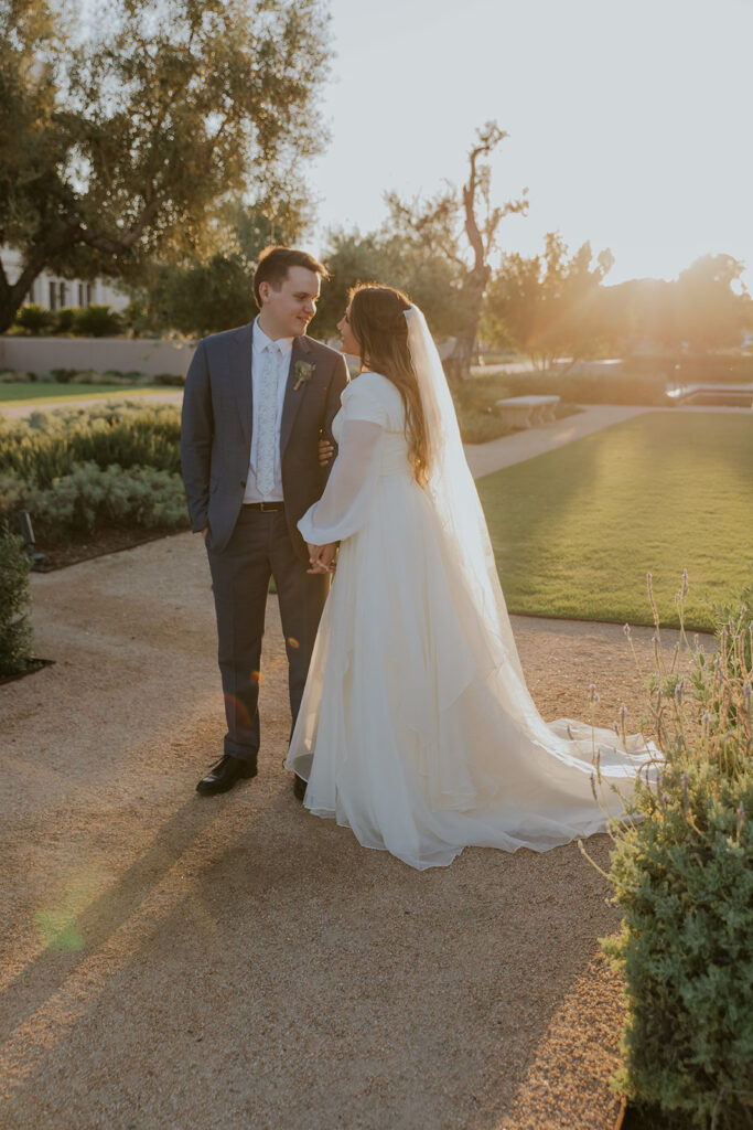 Bridal portrait on Mesa Arizona temple grounds during golden hour. Bridal portrait holding hands dreamy wedding pictures #ChelseyMichelleCoPhotography #Arizonaweddingphotographer #Phoenixphotographer #Mesaphotographer #Gilbertphotographer #ArizonaLDSwedding #MesaArizonaTemple