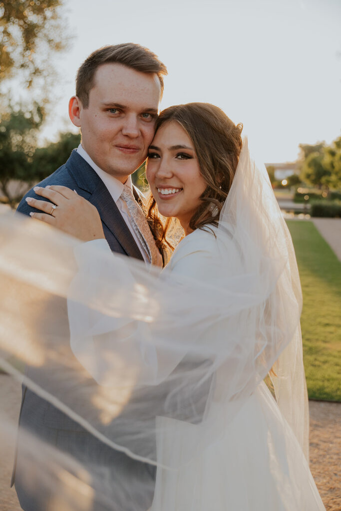 Dreamy Mesa temple first look photos of bride and groom on temple grounds. Veil in wedding photos #ChelseyMichelleCoPhotography #Arizonaweddingphotographer #Phoenixphotographer #Mesaphotographer #Gilbertphotographer #ArizonaLDSwedding #MesaArizonaTemple