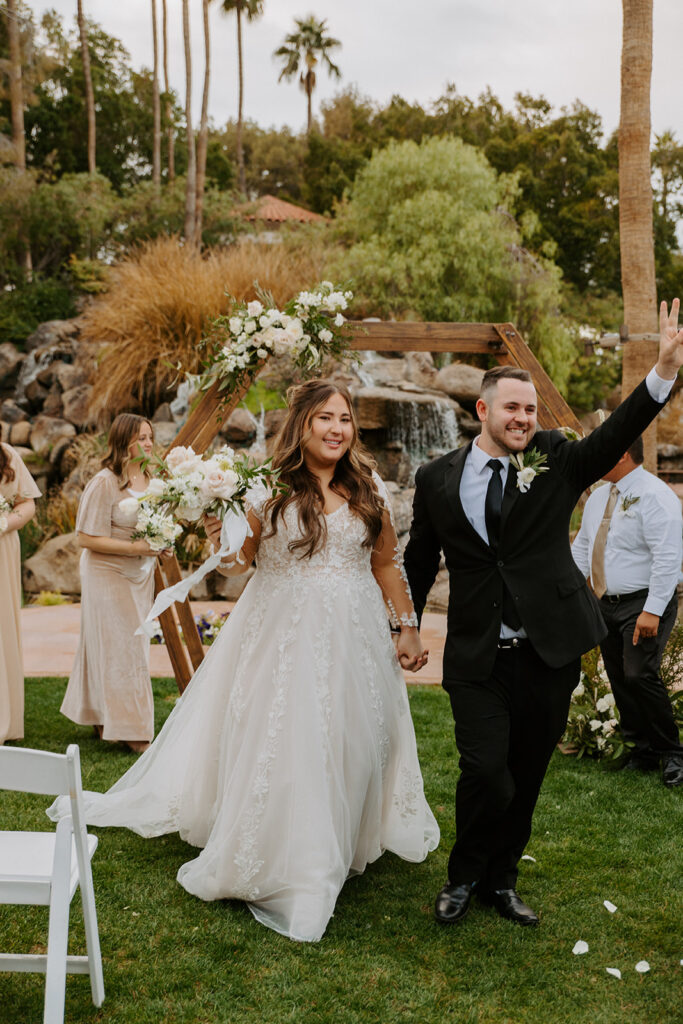 After exchanging rings at a ring ceremony, the groom raises his hand in celebration. The couple stands in front of a beautifully decorated wooden arch.
#ChelseyMichelleCoPhotography #Arizonaweddingphotographer #Gilbertphotographer #GilbertLDSwedding #TemplePhotographer
