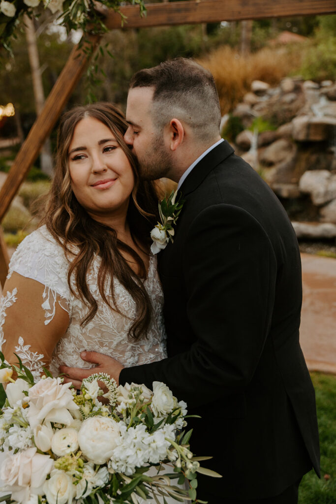 A beautiful bride smiles off into the distance as her groom leans in for a peck on the cheek. The bride’s bouquet shines in the corner of the image taken by Chelsey Michelle Co Photography.
#ChelseyMichelleCoPhotography #Arizonaweddingphotographer #Gilbertphotographer #GilbertLDSwedding #TemplePhotographer
