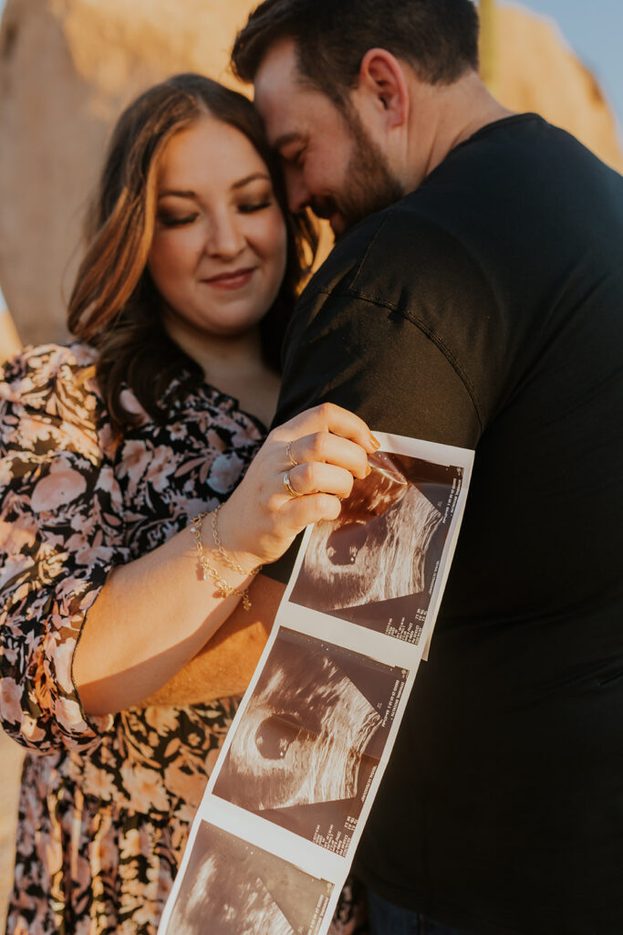 Chelsey Michelle Co Photography, an East Valley Arizona photographer, helps a sweet couple reveal they are pregnant by showcasing ultrasound pictures during a maternity photoshoot.
#ChelseyMichelleCoPhotography #MaternityPhotos #EastValleyAZ #familyphotos
