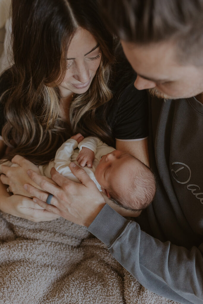 New mom and dad stare at their precious bundle of joy, less than 24 hours old. Newborn photography Arizona Gilbert memory #fresh48 #GilbertAZnewbornphotography #newbornphotographer#chelseymichellephotography#siblingphotography
